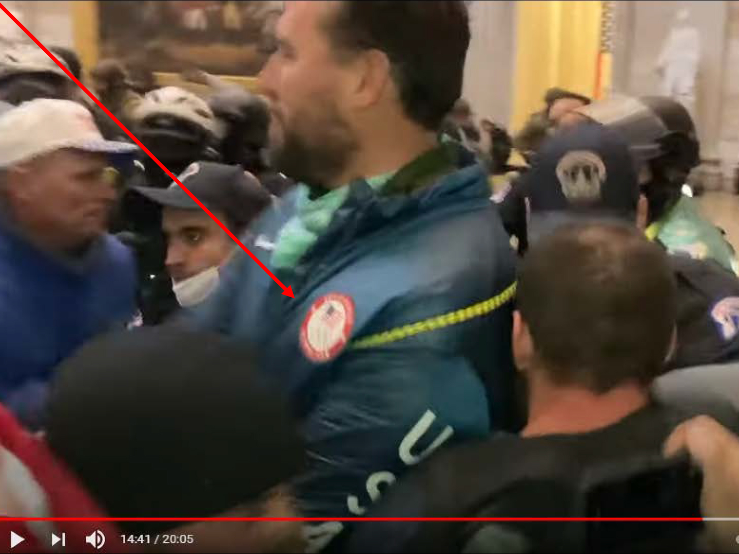 caption: A screenshot from the Jan. 6 U.S. Capitol insurrection allegedly shows gold medalist swimmer Klete Keller wearing an Olympic jacket while inside the Rotunda. He is facing three criminal counts: obstructing law enforcement, knowingly entering a restricted building without lawful authority and violent entry and disorderly conduct on Capitol grounds.