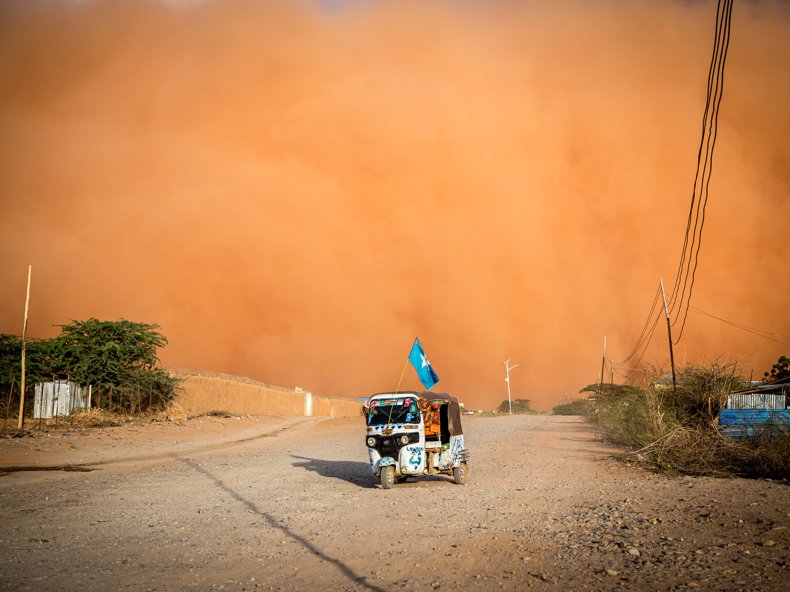 caption: A tuktuk drives during a sandstorm in Somalia in April. The United Nations says a multi-year drought in East Africa is evidence of "mounting and ever-increasing climate risks."