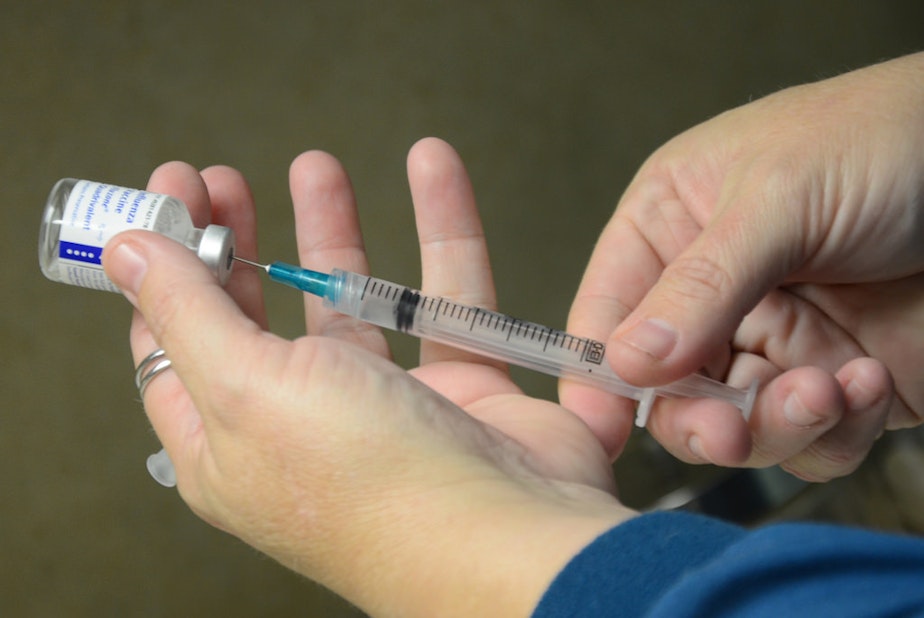 caption: FILE: Cindy Andrews, registered nurse at Jefferson City Medical Group, gets an injectable flu vaccination prepared for a patient on Tuesday, Oct. 21, 2014 in Jefferson City, Missouri.