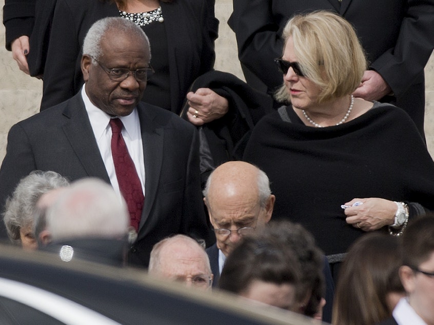 caption: Supreme Court Associate Justice Clarence Thomas, left and his wife Virginia Thomas, right, leave the the Basilica of the National Shrine of the Immaculate Conception in Washington after attending funeral services of the late Supreme Court Associate Justice Antonin Scalia, on Feb. 20, 2016.