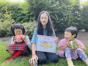 caption: Bellevue's Rebecca Wu holds her winning illustration for the national Doodle for Google competition, along with her two sisters. 