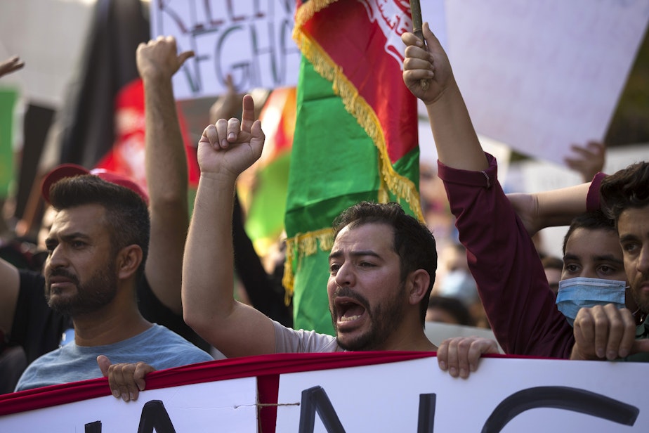 caption: About 100 people attended a rally and march to stand in solidarity with Afghans on Saturday, August 28, 2021, at Westlake Park in Seattle. "What is happening in Afghanistan is devastating," said Shugla Kakar, with Afghans of Seattle. "We're trying to amplify Afghan voices and experiences, and push for urgent action by our federal, state and local leaders to help evacuate those at grave risk in Afghanistan while also supporting the incoming Afghan refugees in our state."