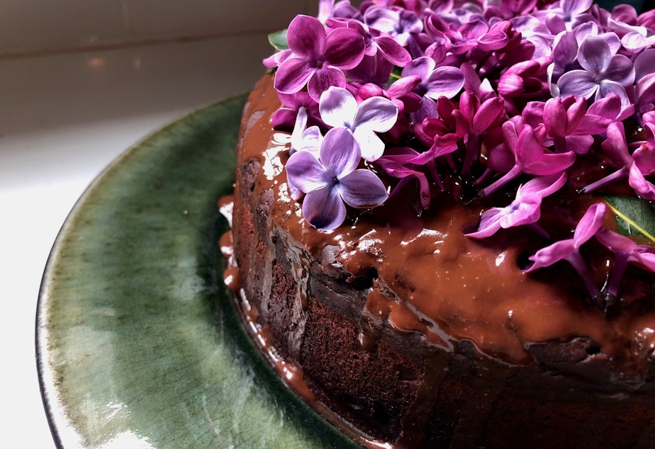 caption: Lilacs and other woody plants are fire-resistant. The lilac flowers are also fully edible and make for a colorful and fragrant addition to baked goods and salads when the plants bloom in the spring. Chocolate cake by KUOW producer Kristin Leong. 