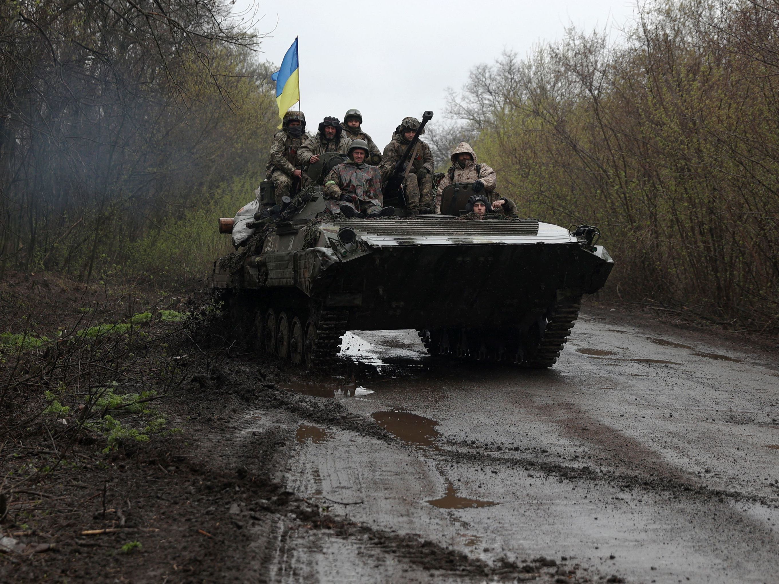 caption: Ukrainian soldiers stand on an armored personnel carrier not far from the front-line with Russian troops in Izyum district, Kharkiv region, on Monday.