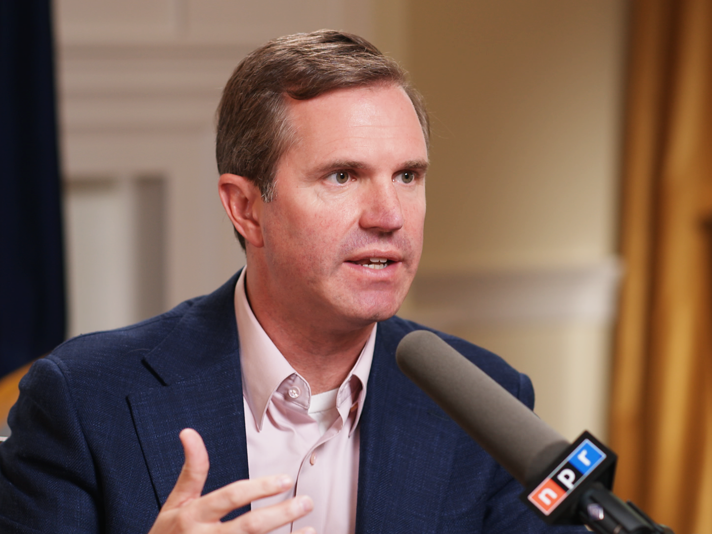caption: Kentucky Governor Andy Beshear speaks during an interview with NPR's <em>Morning Edition.</em>