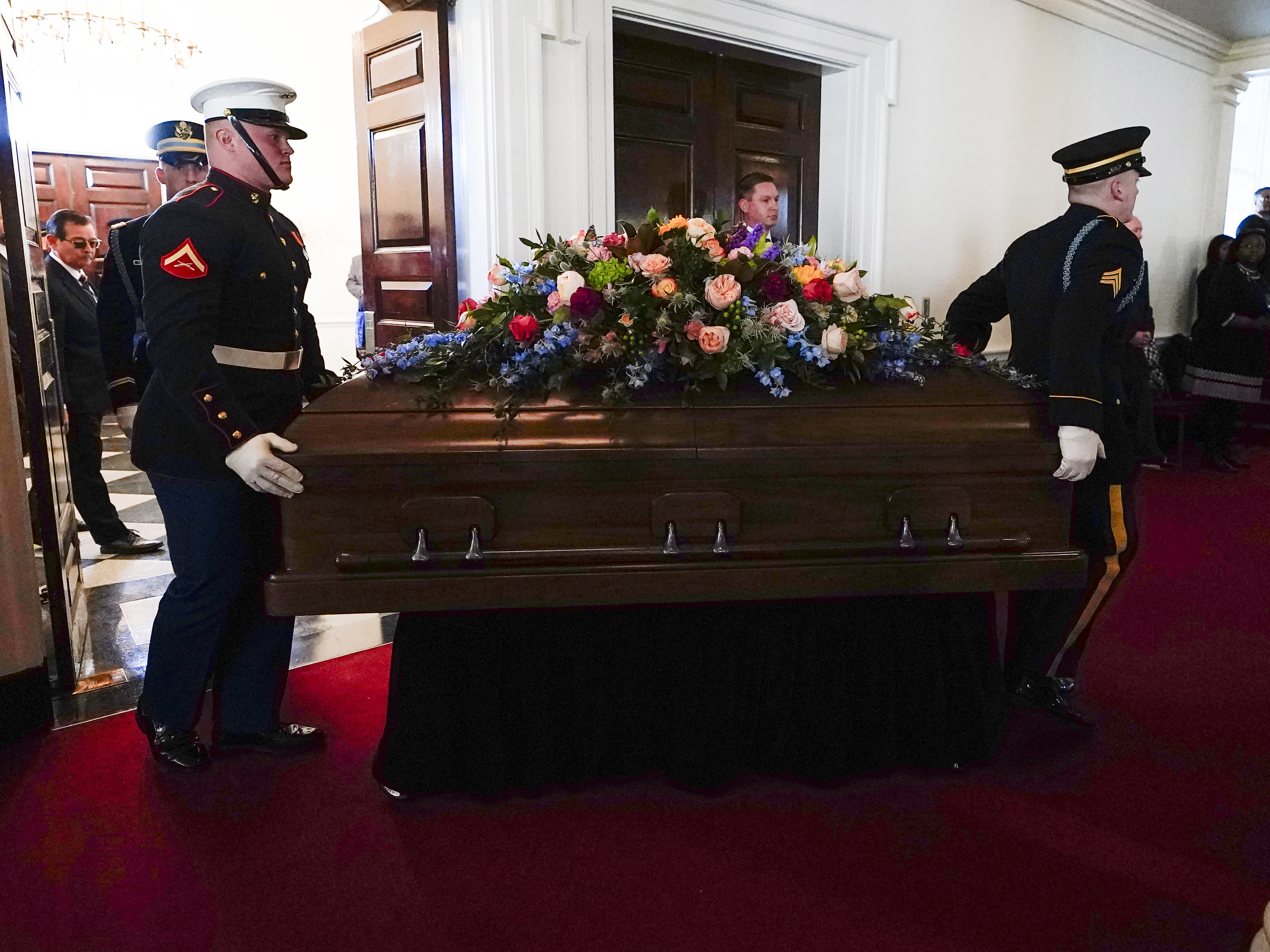 caption: An Armed Forces body bear teams moves the casket for former first lady Rosalynn Carter into Glenn Memorial Church at Emory University for a tribute service on Tuesday, Nov. 28, 2023, in Atlanta.