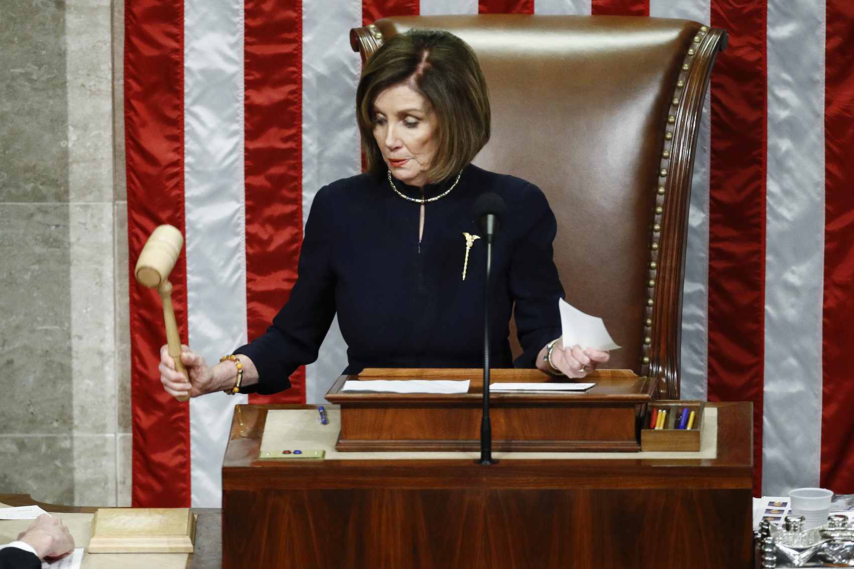 caption: House Speaker Nancy Pelosi of Calif., strikes the gavel after announcing the passage of article II of impeachment against President Donald Trump, Wednesday, Dec. 18, 2019, on Capitol Hill in Washington. (Patrick Semansky/AP)