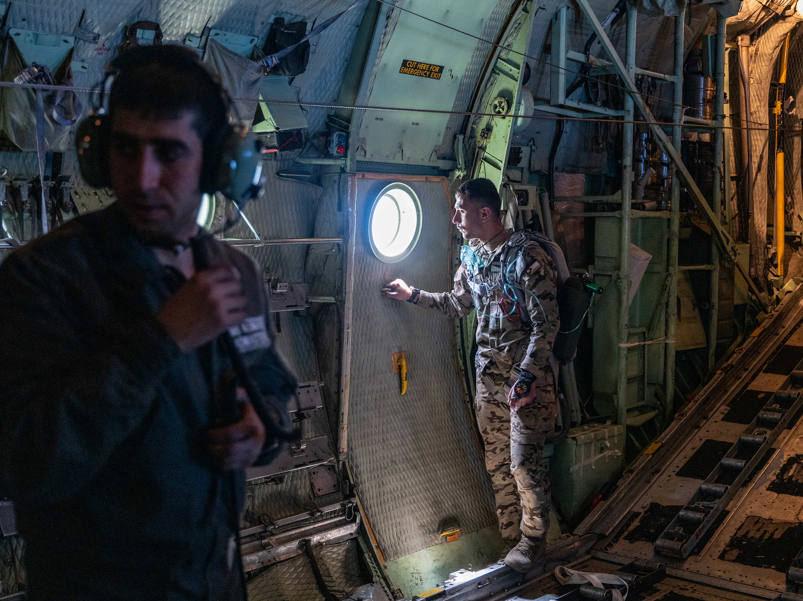 caption: Jordanian air force personnel inside a C-130 aircraft after airdropping pallets of aid over Gaza on Thursday.