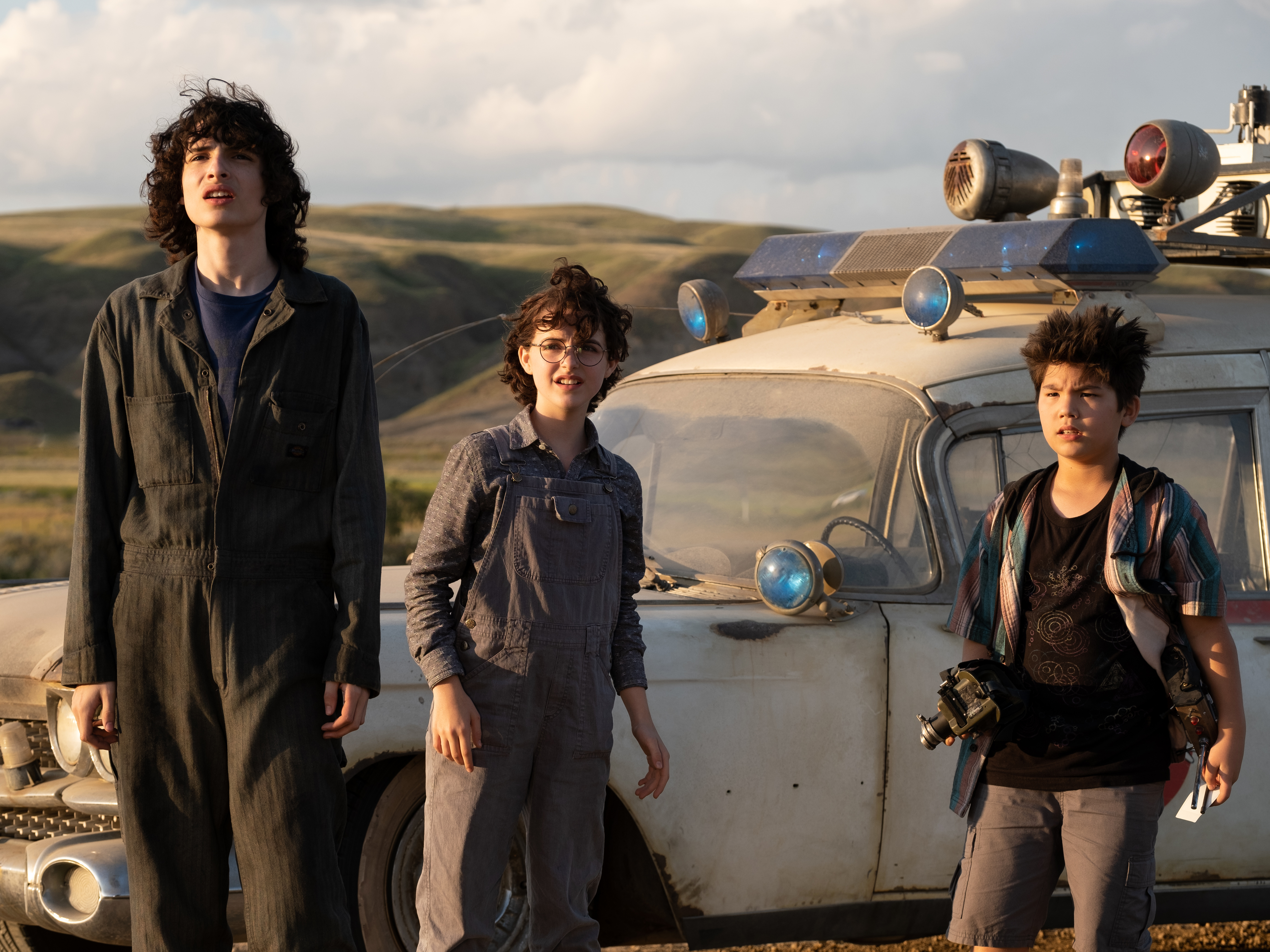 caption: Trevor (Finn Wolfhard), Phoebe (McKenna Grace) and Podcast (Logan Kim).