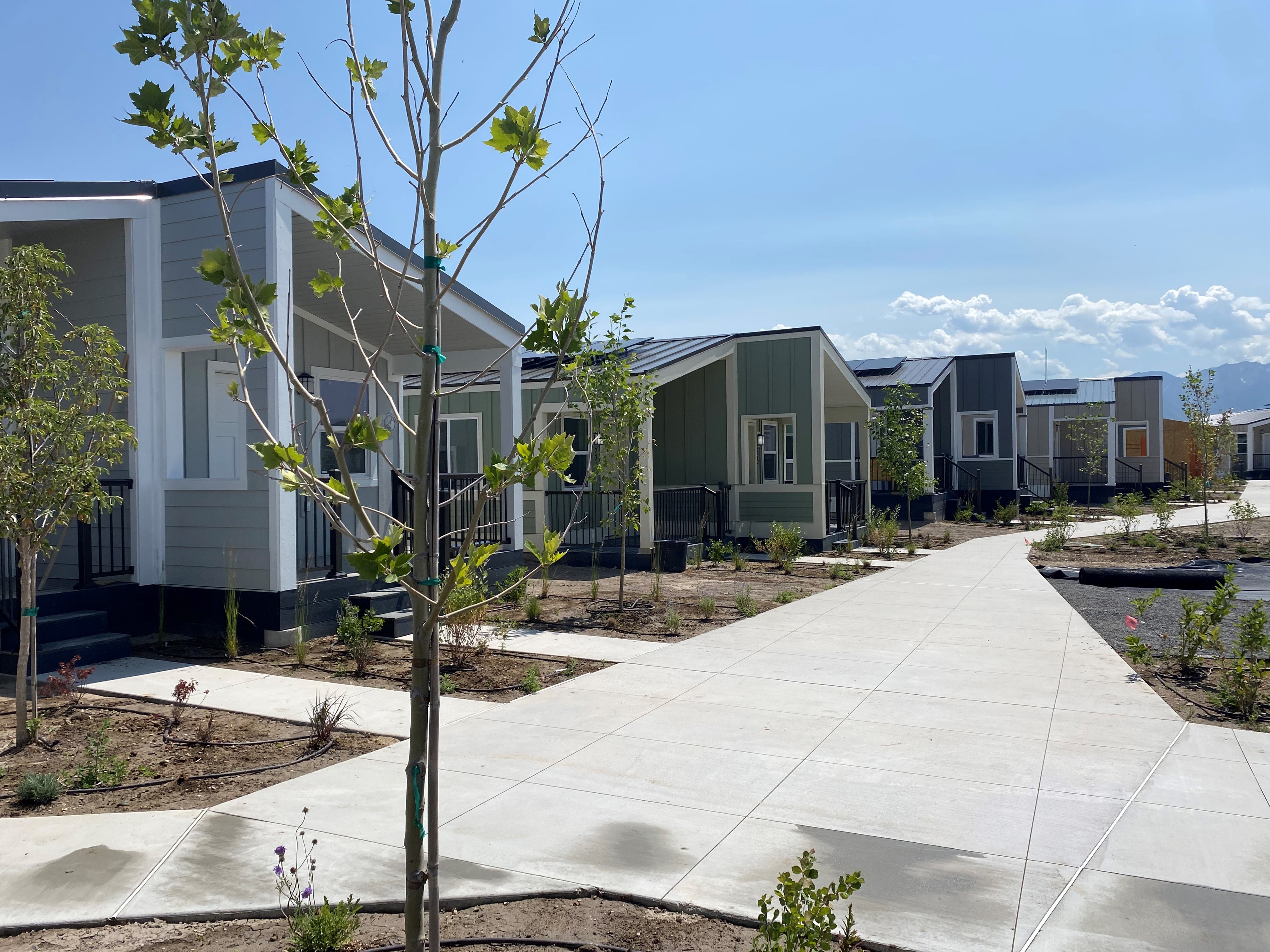 caption: The Other Side Village is building tiny cottages in Salt Lake City as part of its program to help people who've been chronically homeless. The organization also runs businesses to create jobs for residents.