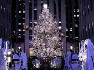 caption: The Rockefeller Center Christmas tree stands illuminated following the 90th annual lighting ceremony, on Nov. 30, 2022, in New York.