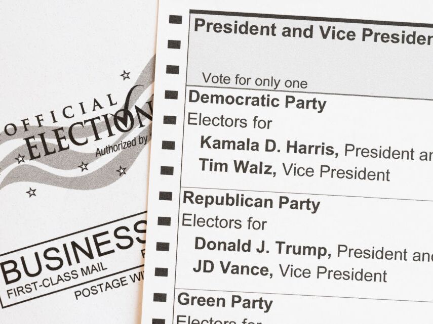 caption: In this photo illustration, an absentee-voter mail-in ballot shows the names of the Democratic and Republican presidential and vice presidential candidates in the 2024 election.