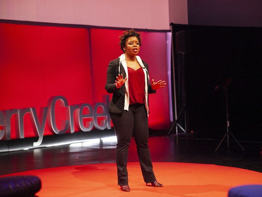 caption: Phylecia Jones on the TED stage.