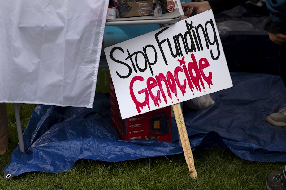 caption: ‘Stop Funding Genocide’ reads a handmade sign as students set up what they are calling the UW Palestine Encampment on Monday, April 29, 2024, on the University of Washington campus in Seattle. 