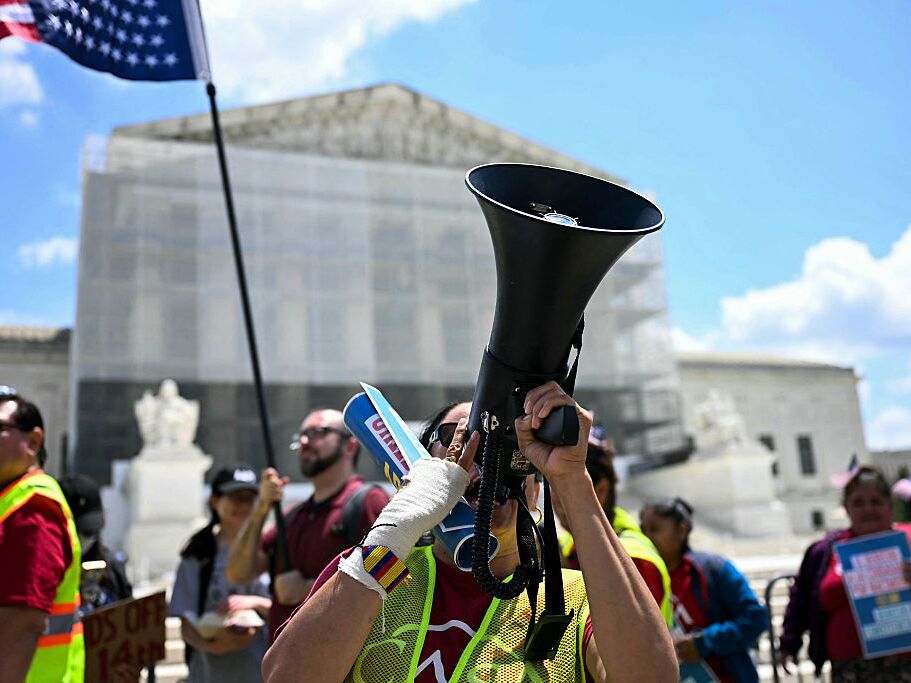 caption: People participate in a protest outside the U.S. Supreme Court on May 15, 2025, over President Trump's move to end birthright citizenship.
