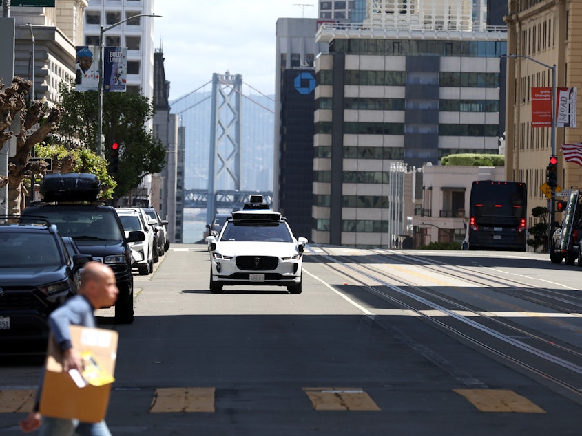 caption: San Francisco has served as a testing ground for autonomous vehicles made by the companies Waymo (pictured above) and Cruise.