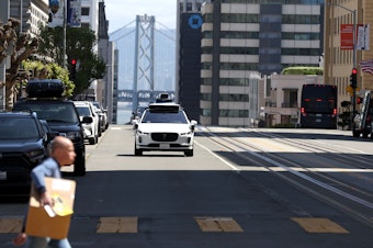 caption: San Francisco has served as a testing ground for autonomous vehicles made by the companies Waymo (pictured above) and Cruise.