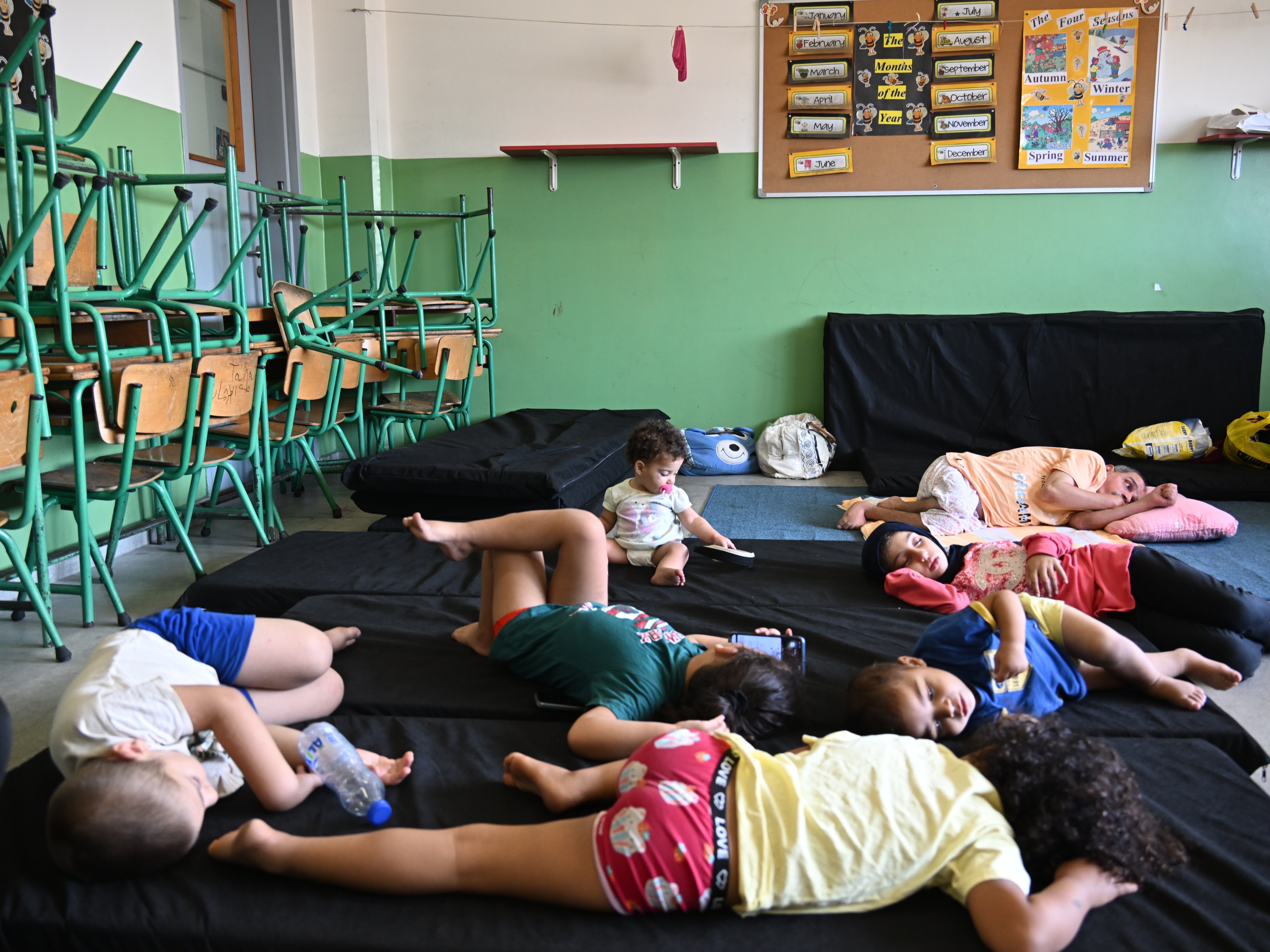 caption: Lebanese who were forced to flee their homes due to Israeli airstrikes have been housed in school buildings in Lebanon's capital of Beirut on Tuesday.