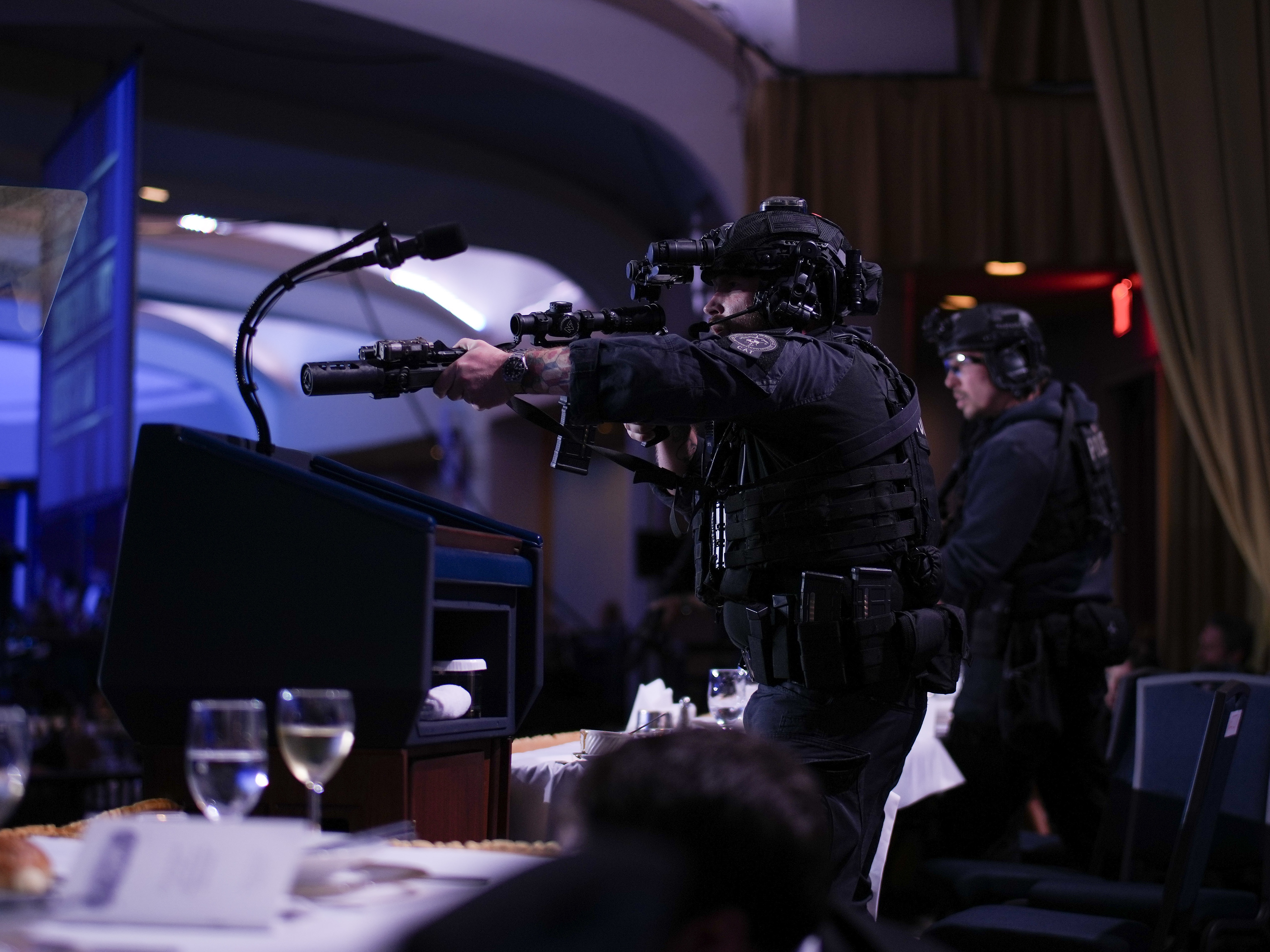 caption: Agents stand guard after the shooting at the annual White House Correspondents Association Dinner on Saturday.
