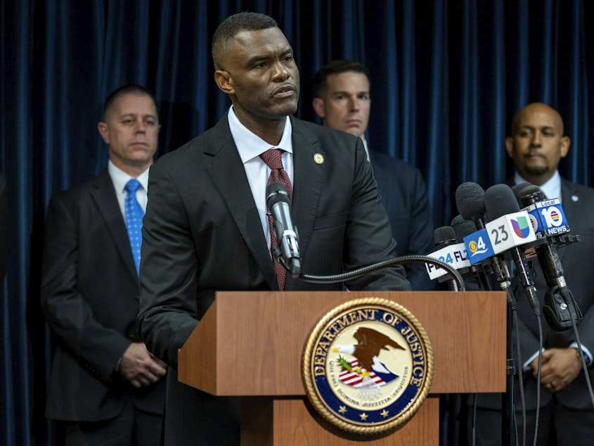 caption: U.S. Attorney Markenzy Lapointe speaks at a news conference in Miami on Wednesday about a network of nursing school operators, centered in South Florida, who allowed students to buy diplomas without the proper training.