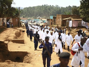 caption: Health workers marched in Butembo on Wednesday to protest the violence they're facing. The demonstration comes in the wake of an attack last Friday in which an epidemiologist from Cameroon was shot and killed.