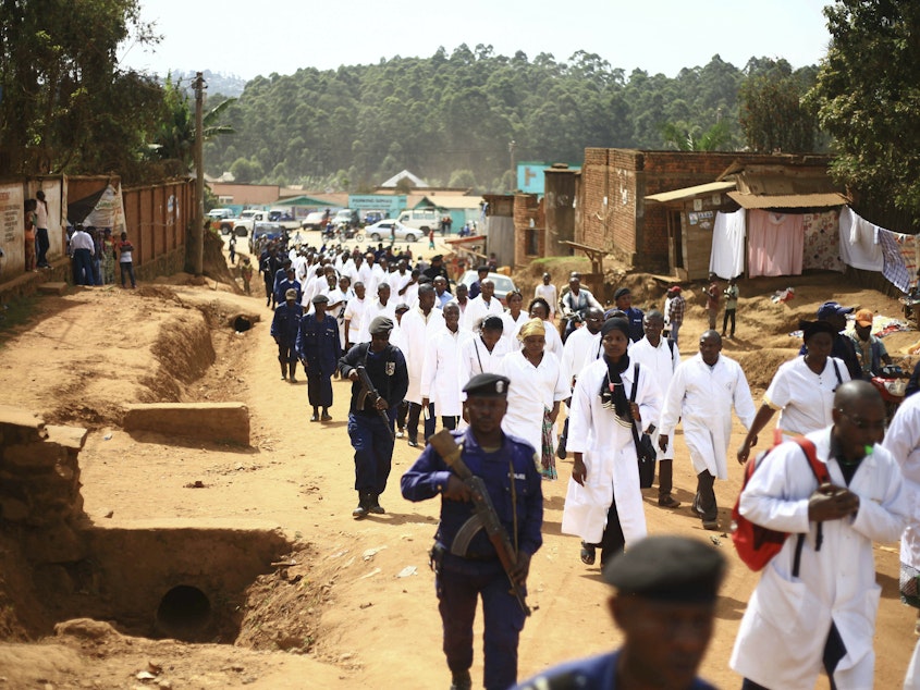 caption: Health workers marched in Butembo on Wednesday to protest the violence they're facing. The demonstration comes in the wake of an attack last Friday in which an epidemiologist from Cameroon was shot and killed.