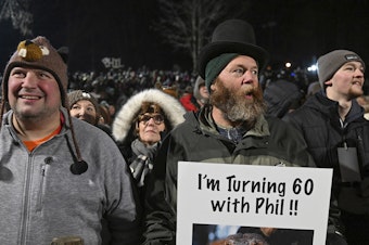 caption: Rory Szwed, left, and Kent Rowan watch the festivities while waiting for Punxsutawney Phil to make his prediction at Gobbler's Knob in Punxsutawney, Pa., early Thursday morning.