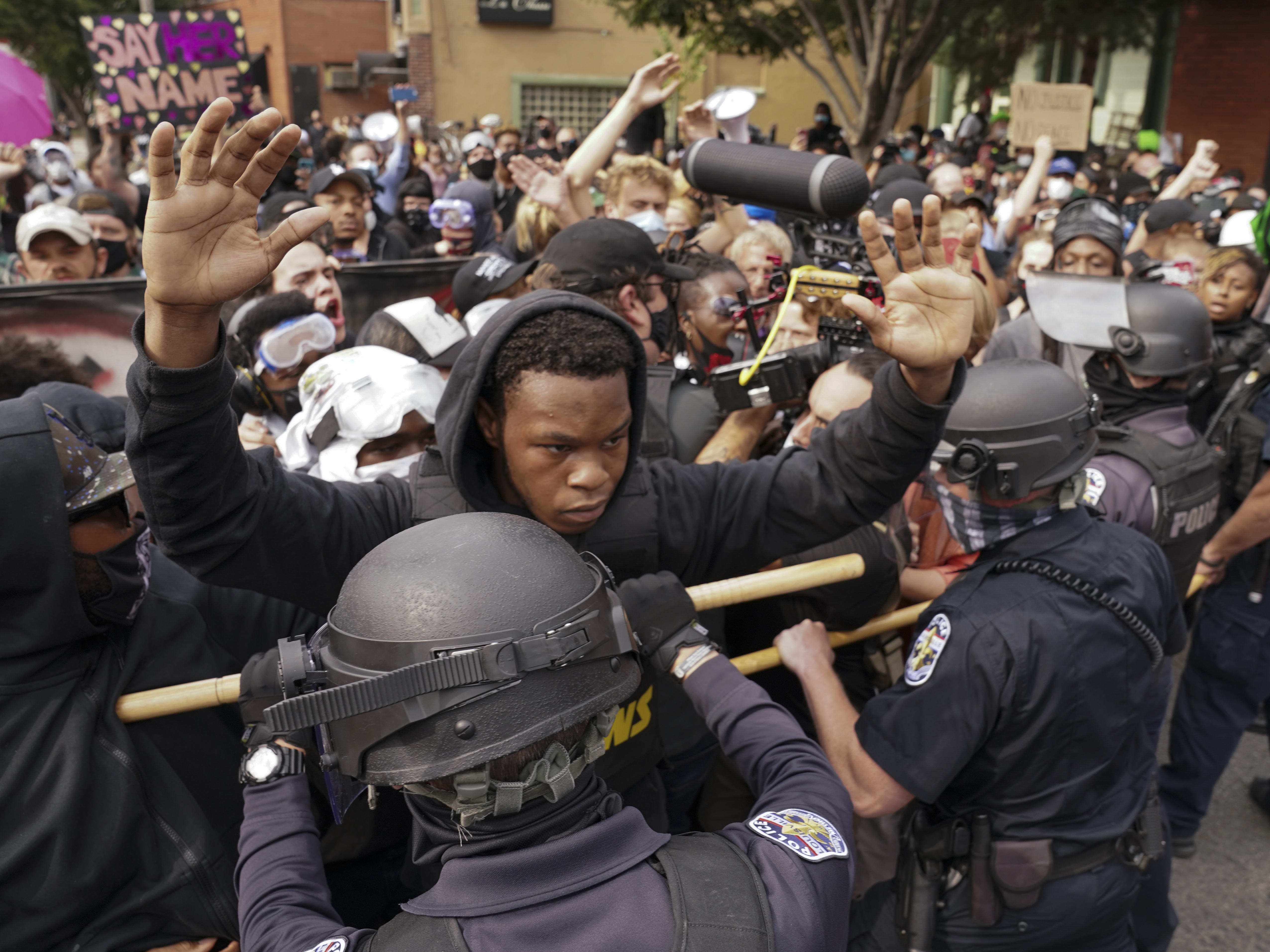 caption: Police and protesters converge during a demonstration, Wednesday in Louisville, Ky. A grand jury has indicted one officer on criminal charges six months after Breonna Taylor was fatally shot by police in Kentucky.