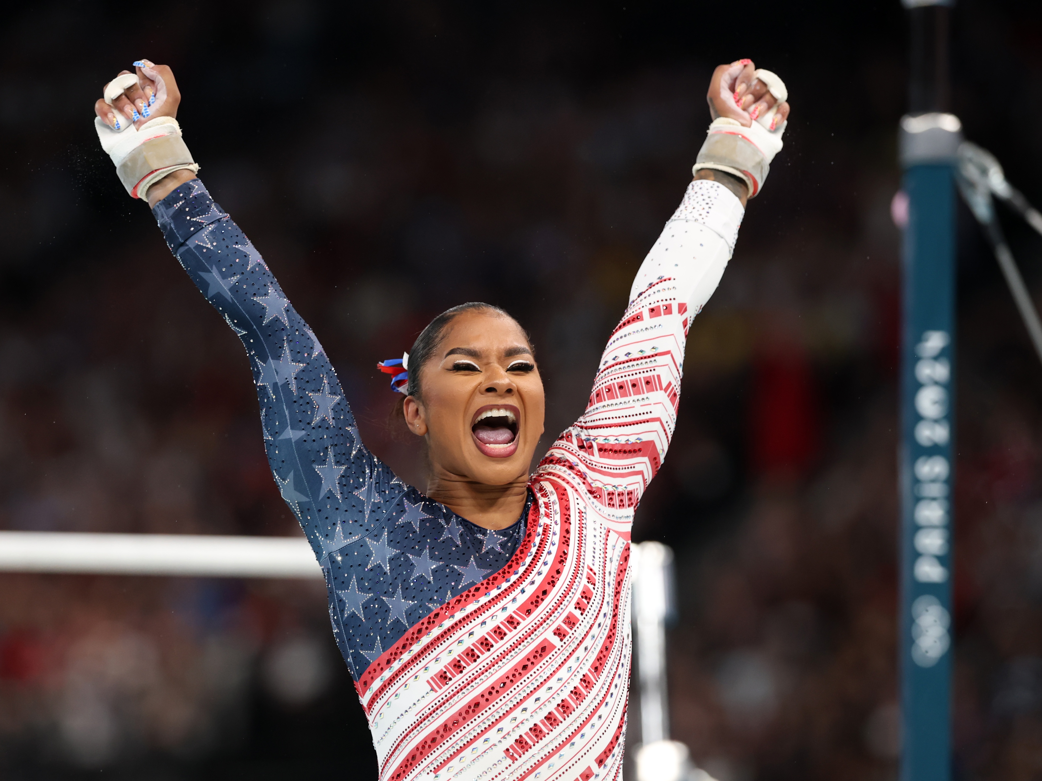 caption: Jordan Chiles of Team USA reacts after finishing her routine on the uneven bars during the Olympic Games in Paris 2024.