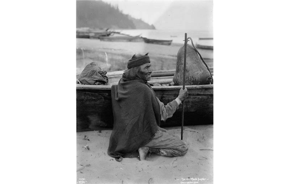 caption: And elder Makah whale hunter with canoe and floats at Neah Bay, 1900. By 1900, when this photograph was taken, whale hunting had become less important economically to the Makah because commercial whaling fleets had depleted the whale population. The cultural significance of the whaler endured, however, and great prestige still surrounded successful hunters. 