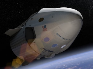 caption: An arist's depiction of SpaceX's Crew Dragon, which is set to take NASA astronauts to the International Space Station May 27.
