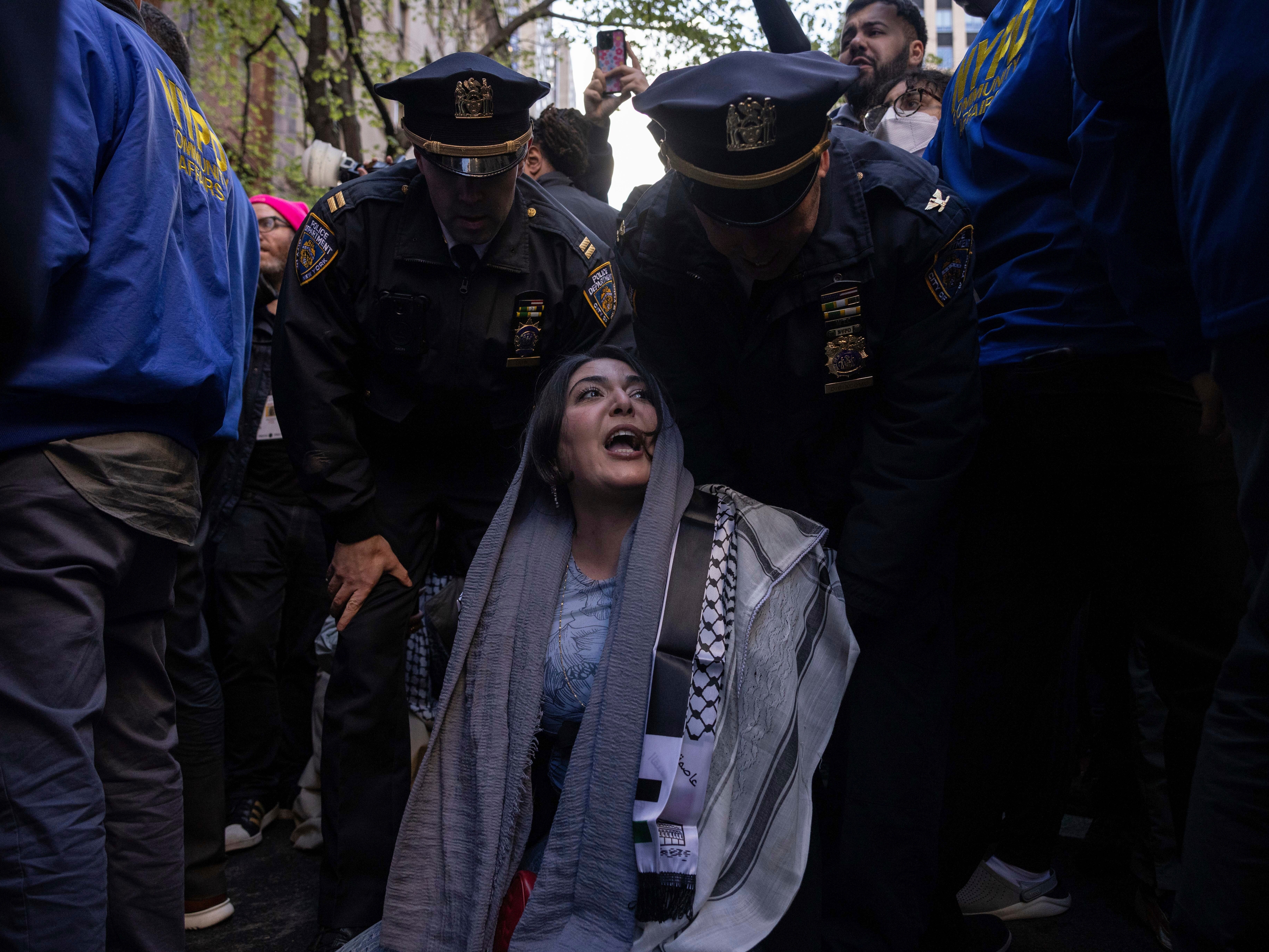 caption: Police detain Nerdeen Kiswani, an organizer of pro-Palestinian demonstration group "Within Our Lifetime" during a protest on Friday, April 12, 2024, in New York.