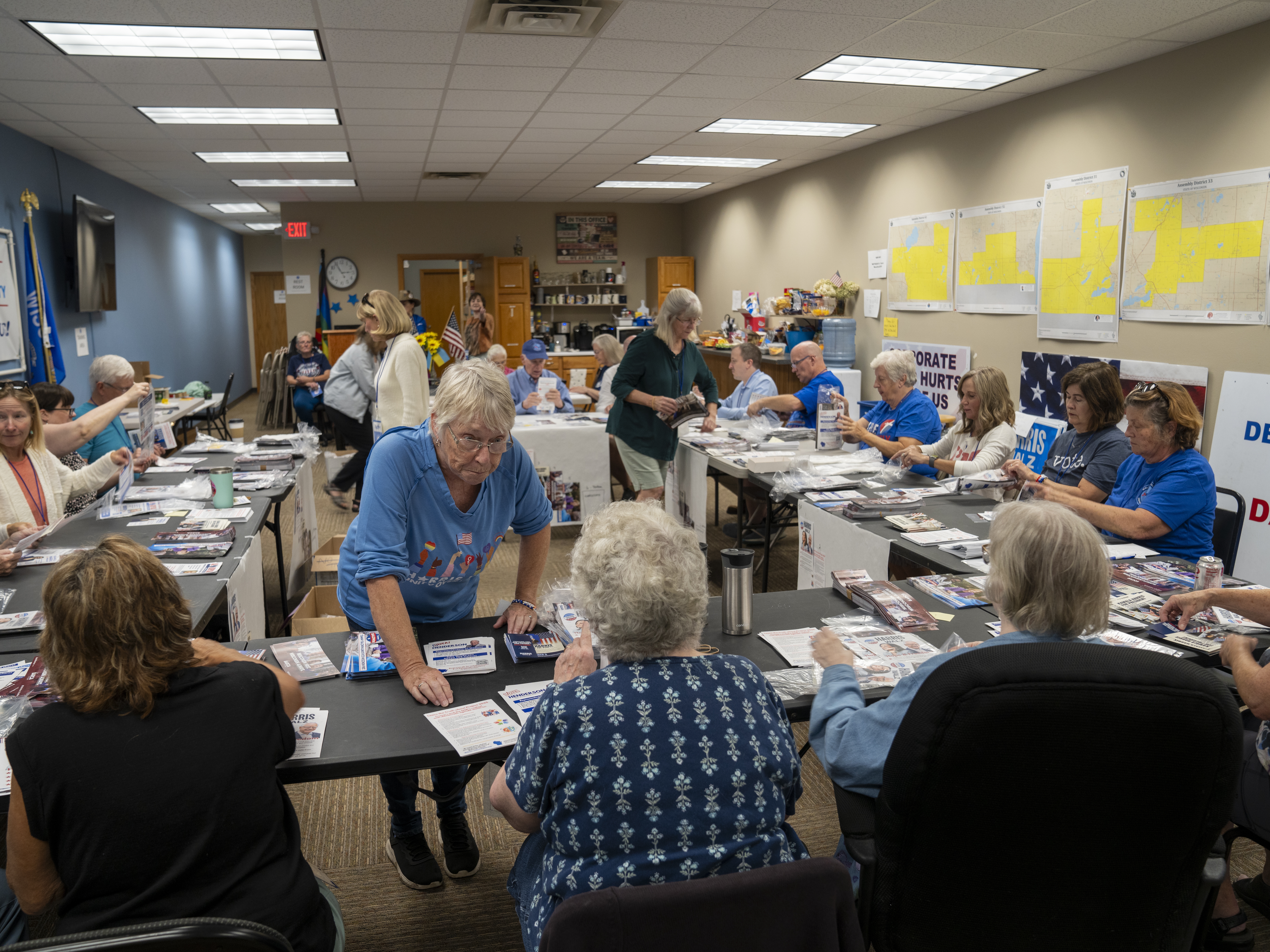 caption: Volunteers for the Walworth County Democrats fold pamphlets for canvassers ahead of this year's presidential election.
