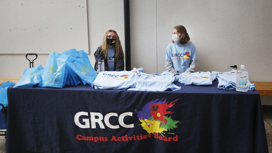 caption: Students at Grand Rapids Community College pass out t-shirts to promote virtual student life offerings during the fall semester.