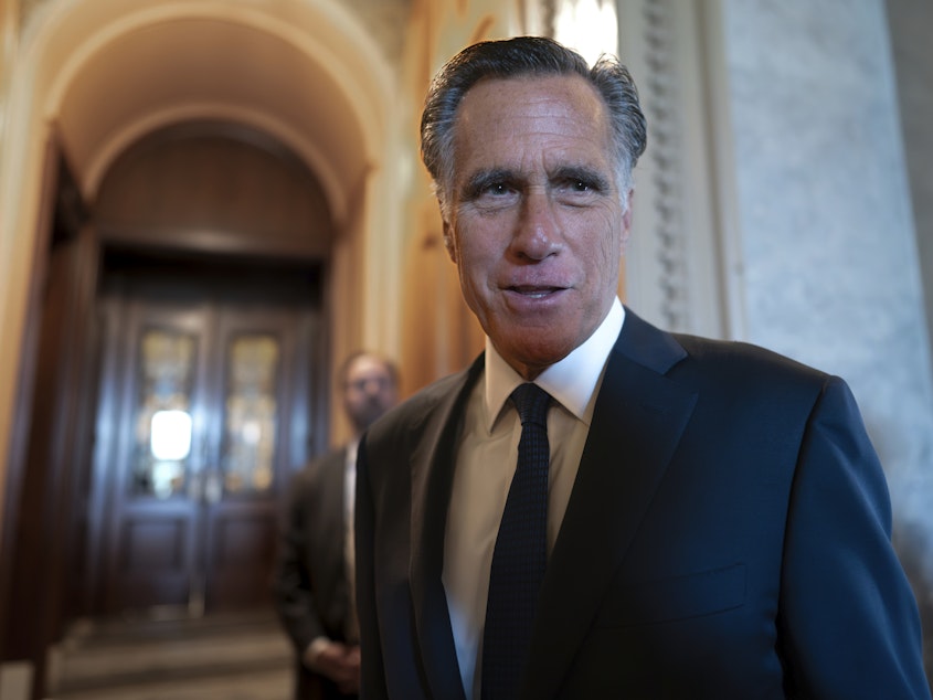 caption: Sen. Mitt Romney, R-Utah, and other senators arrive at the chamber for votes at the U.S. Capitol on September 6.