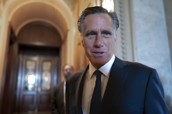 caption: Sen. Mitt Romney, R-Utah, and other senators arrive at the chamber for votes at the U.S. Capitol on September 6.