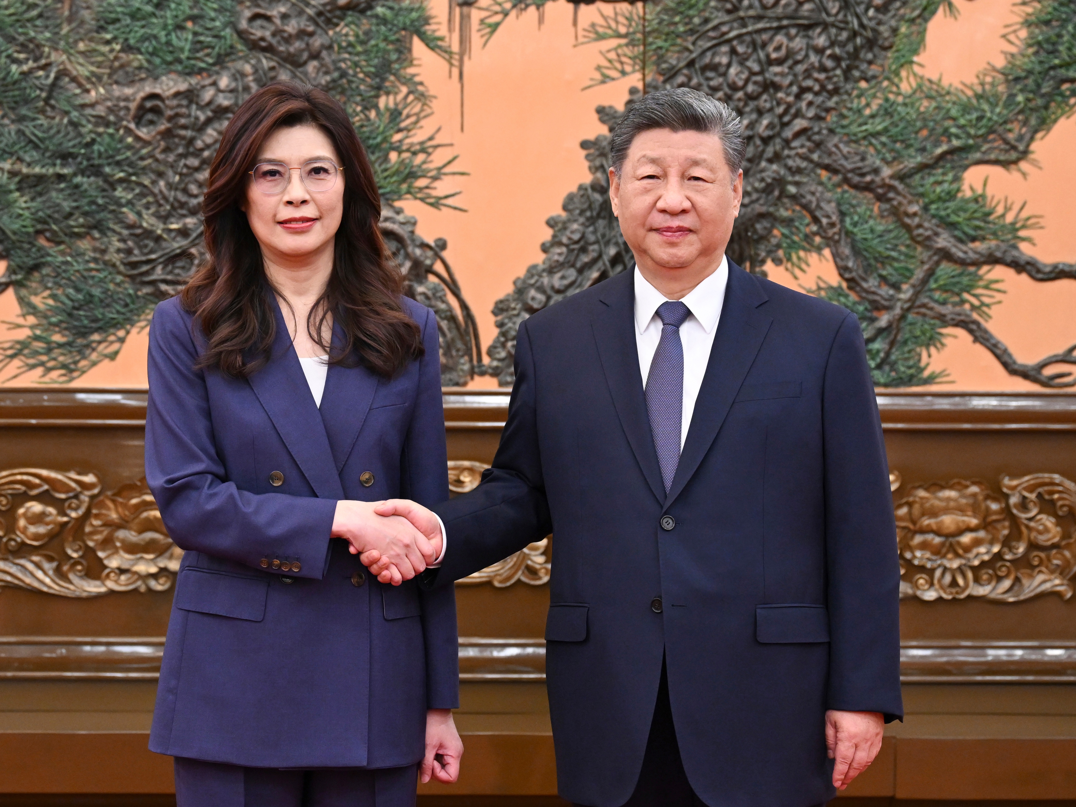 caption: In this photo released by Xinhua News Agency, Chinese President Xi Jinping, right shakes hands with Kuomintang (KMT) party leader Cheng Li-wun in Beijing on Friday, April 10, 2026.