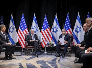 caption: President Joe Biden, center left, during a meeting with Israeli Prime Minister Benjamin Netanyahu, center right, in Tel Aviv, Israel, Wednesday.