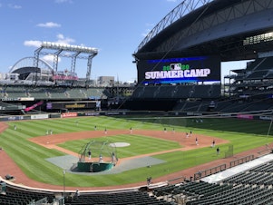 caption: Seattle Mariners players are gearing up for the start of a shortened regular season. At their home ballpark, summer training is underway this week with strict coronavirus restrictions.