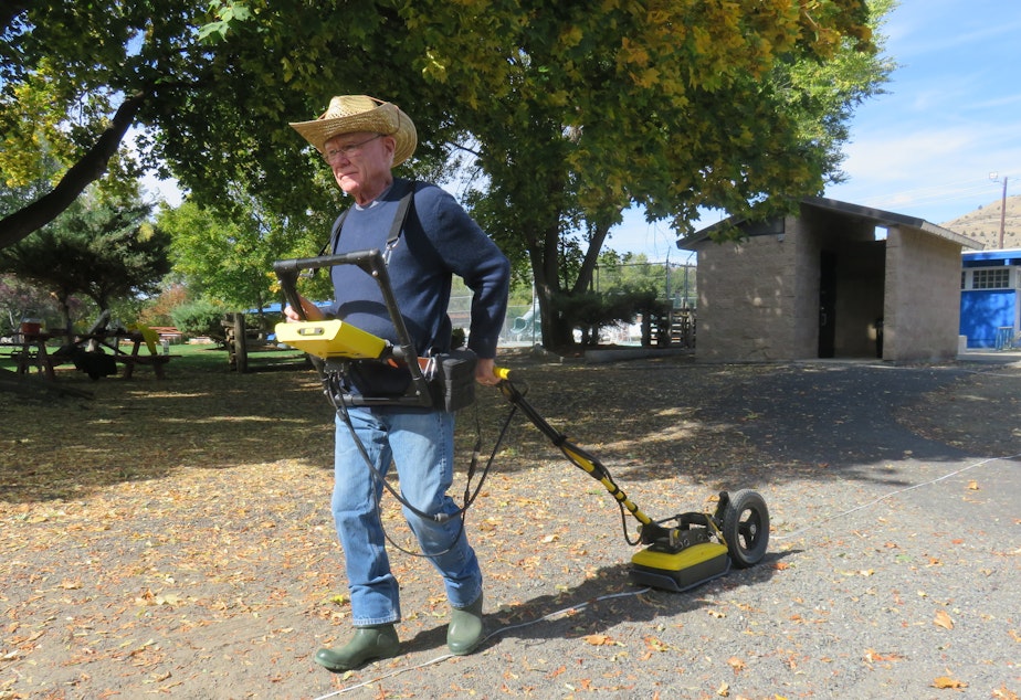 caption: Lew Somers pulls a ground-penetrating radar instrument at Kam Wah Chung State Heritage Site