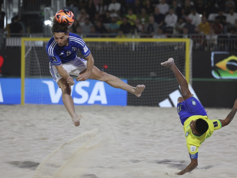 caption: Datinha of Brazil does a bicycle kick Feb. 25 as Italy's Tommaso Fazzini defends during the FIFA Beach Soccer World Cup final between Brazil and Italy at the Dubai Design District Stadium in Dubai, United Arab Emirates.
