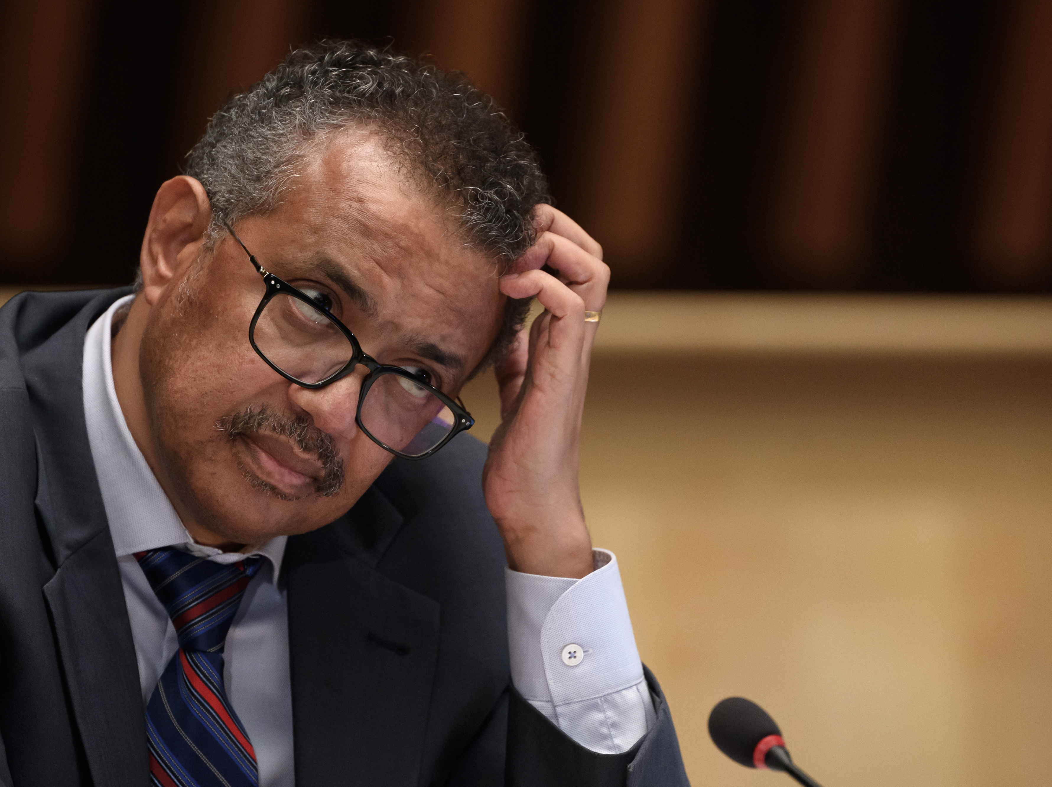 caption: World Health Organization Director-General Tedros Adhanom Ghebreyesus at a news conference last month in Geneva. He is urging countries to join a pact aimed at ensuring access to drugs to prevent COVID-19.
