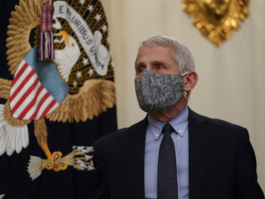 caption: Dr. Anthony Fauci, director of the National Institute of Allergy and Infectious Diseases, arrives for an event on the coronavirus with President Biden at the White House on Thursday.
