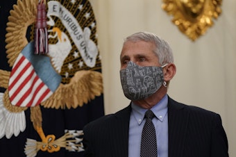 caption: Dr. Anthony Fauci, director of the National Institute of Allergy and Infectious Diseases, arrives for an event on the coronavirus with President Biden at the White House on Thursday.