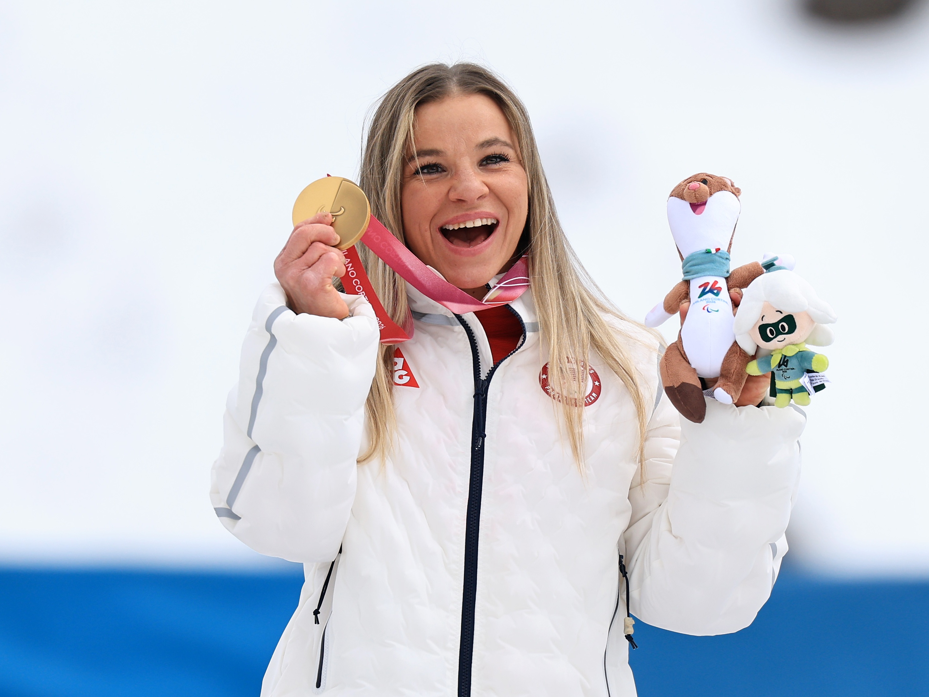 caption: Oksana Masters poses with one of her gold medals in Italy. Out of her 24 total medals from both Summer and Winter Paralympics, 14 are gold.