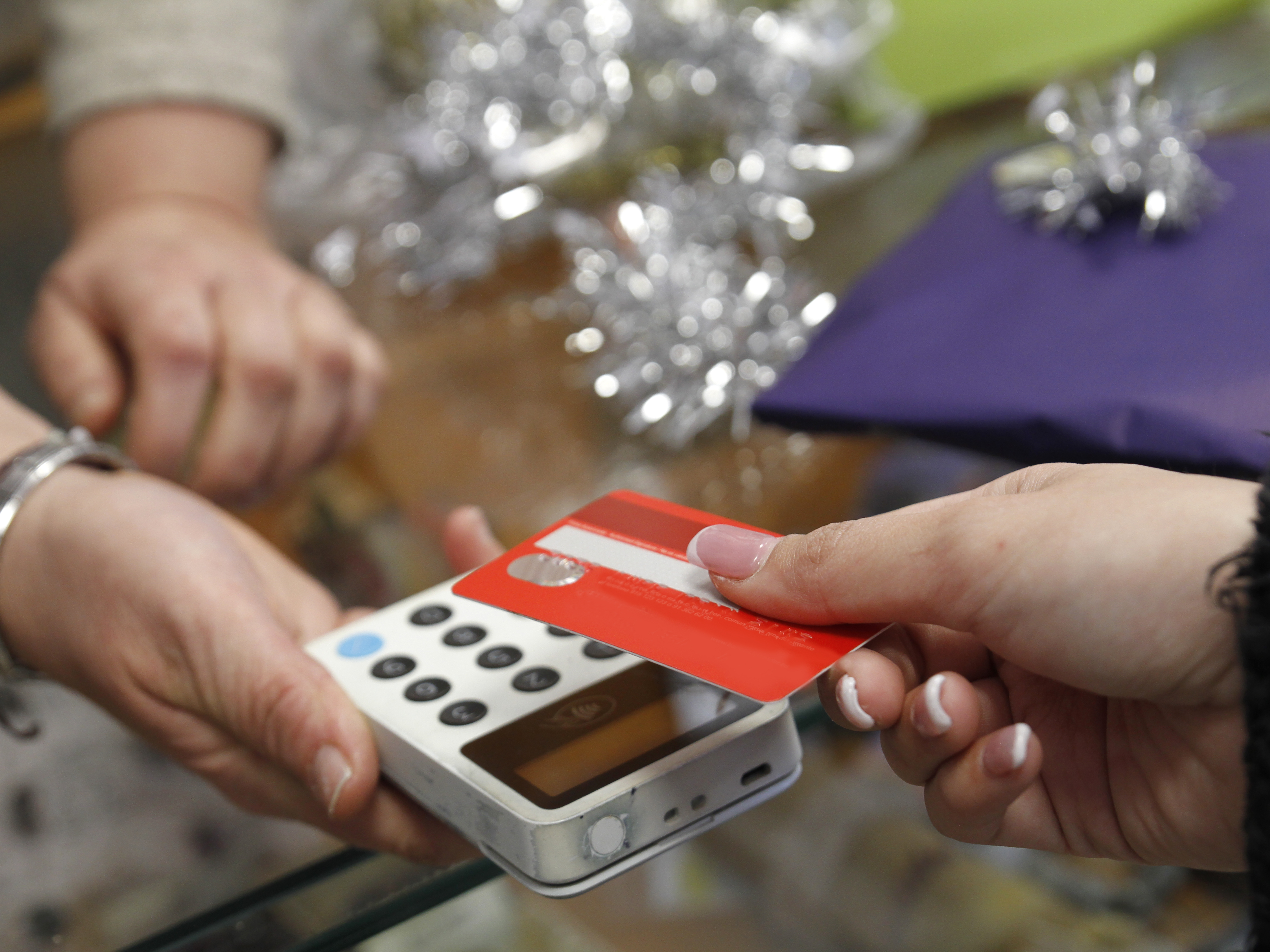 caption: Retail spending dipped in November compared to October, as holiday sales bit into inflation.