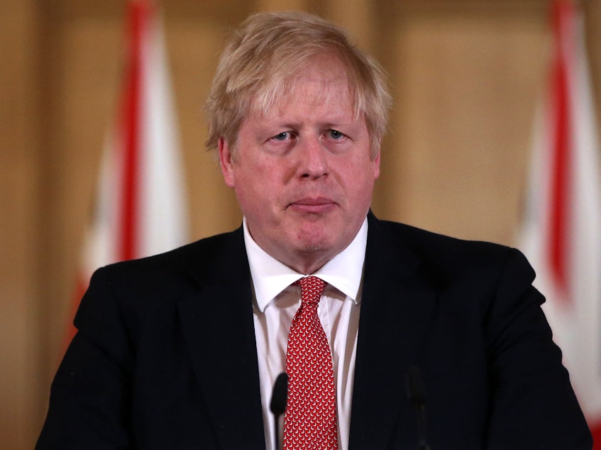 caption: British Prime Minister Boris Johnson, seen on March 22, tested positive for the coronavirus 10 days ago. He's been admitted to a hospital for testing.