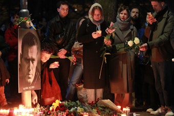 caption: Protesters light candles on Friday in front of the Russian Embassy in Prague after the announcement that the Kremlin's most prominent critic, Alexei Navalny, had died in an Arctic prison.