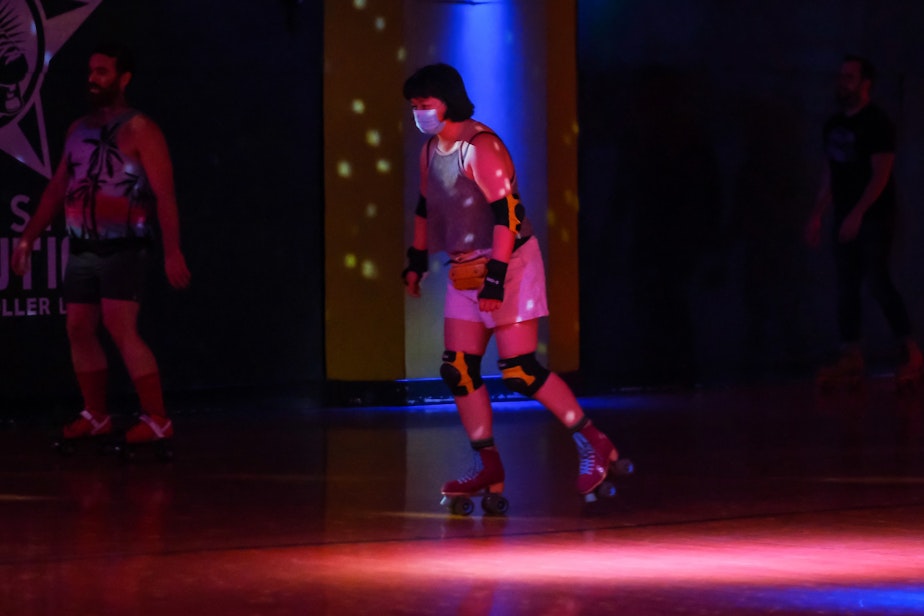 caption: Miranda Sheh wears her mask as she skates at Southgate Roller Rink in White Center, August 2, 2021. Southgate and other area establishments have begun requiring their patrons show proof of vaccination before entering.