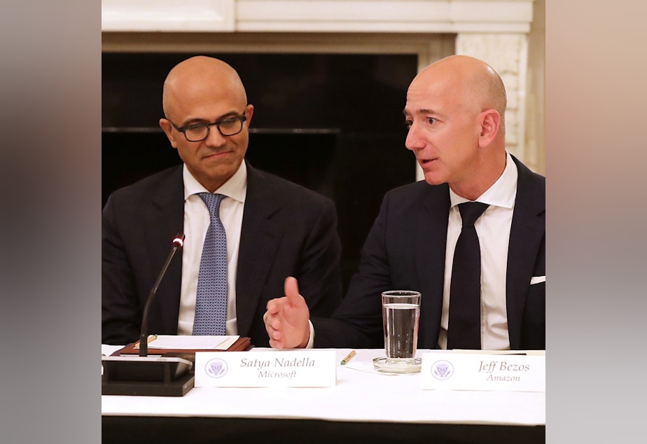 caption: President Trump met with Microsoft CEO Satya Nadella and Amazon CEO Jeff Bezos as part of the American Technology Council in June 2017.